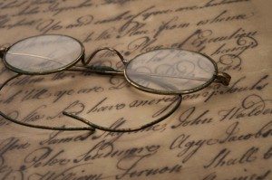 Old glasses on the vintage document