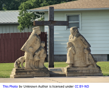 German genealogy by popular US online genealogists, Price Genealogy: image of a stone sculpture consisting of german immigrants standing in front of a cross. 