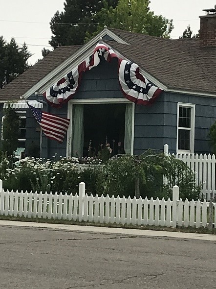 Sons of the American Revolution by popular US online genealogists, Price Genealogy: image of a house decorated with American flags. 