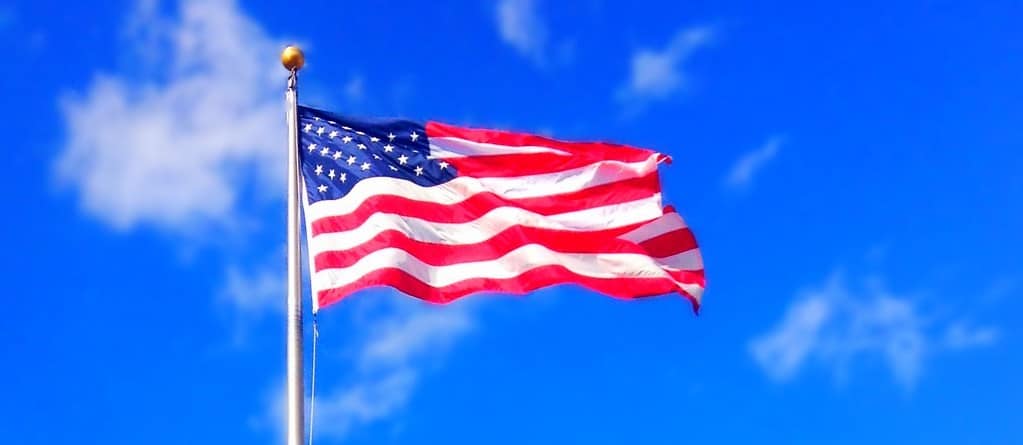 Naturalization Research by popular US online genealogists, Price Genealogy: image of an American flag waving in the wind. 